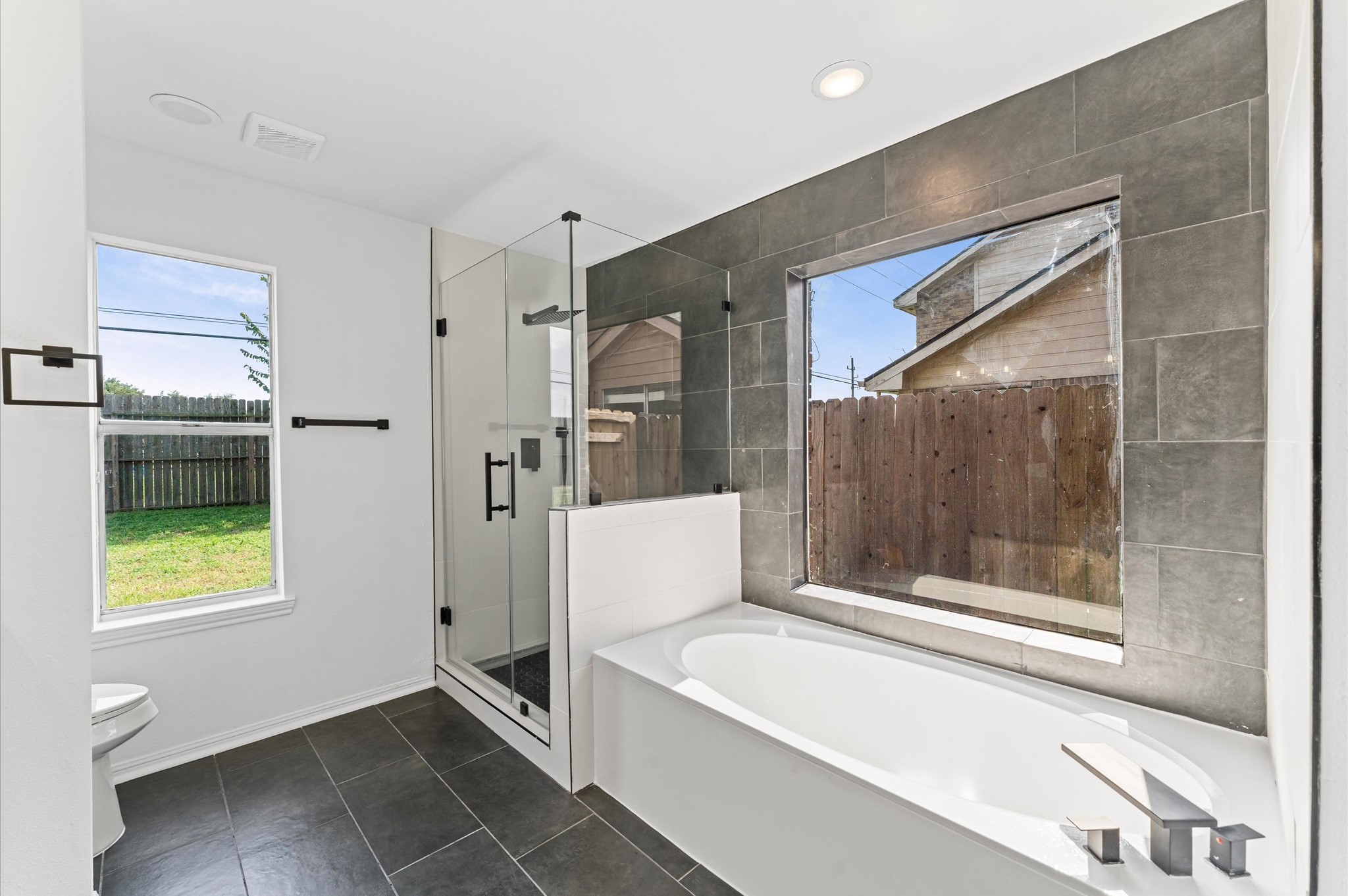 17527 Hamilwood Drive Cypress, TX 77433 - Photo 20 of 32 a bathroom with a bathtub and a shower