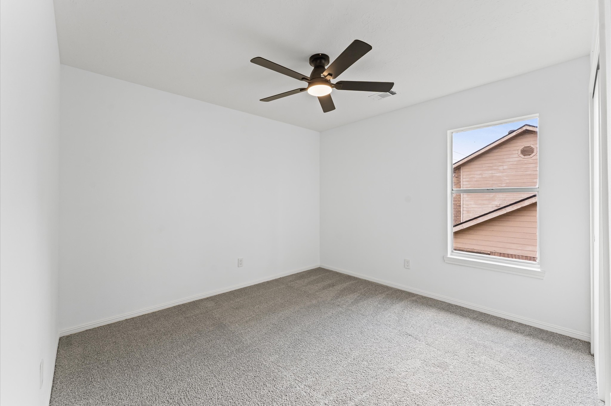 17527 Hamilwood Drive Cypress, TX 77433 - Photo 25 of 32 an empty room with window and ceiling fan