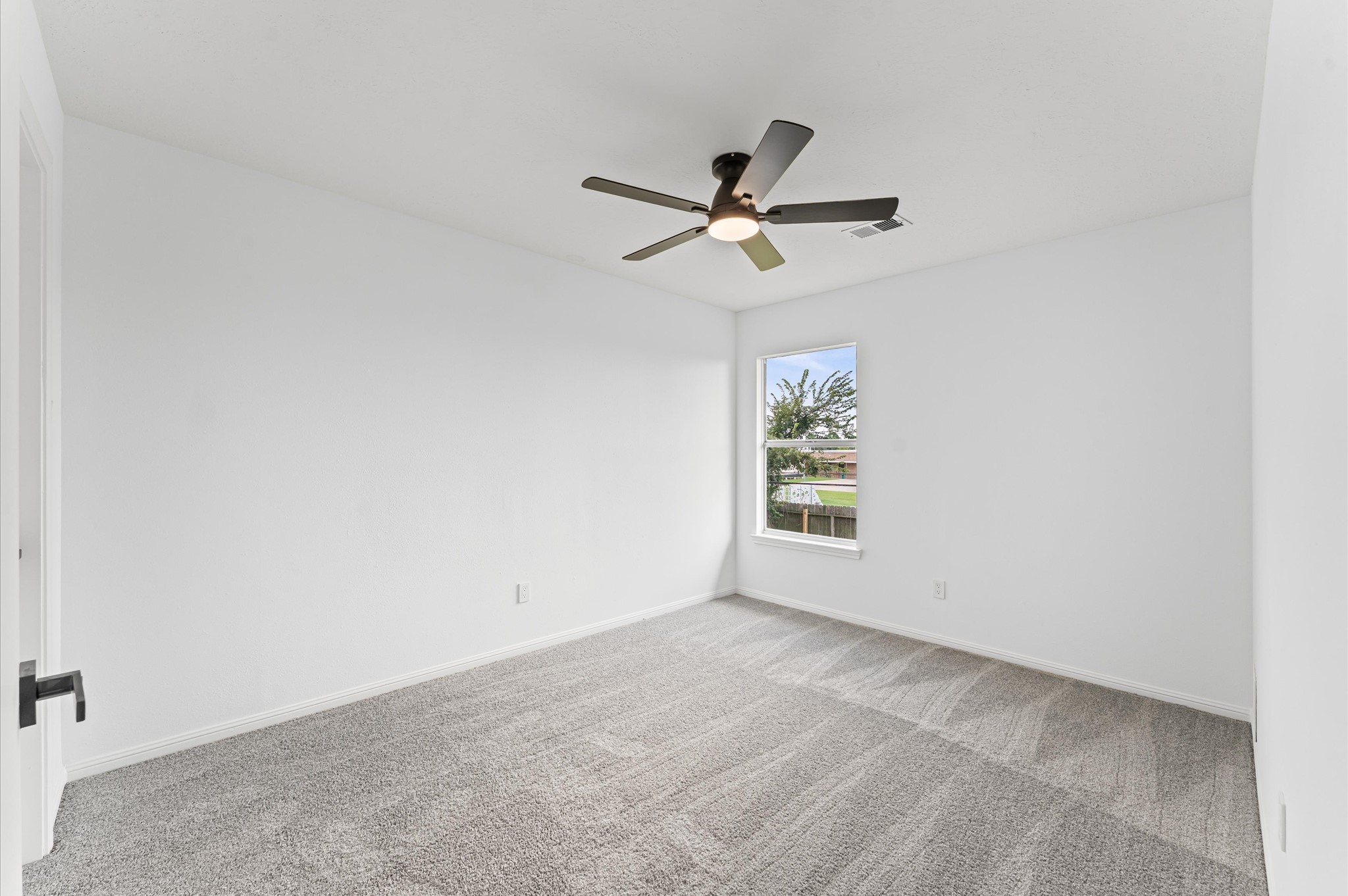 17527 Hamilwood Drive Cypress, TX 77433 - Photo 27 of 32 an empty room with a window and a fan