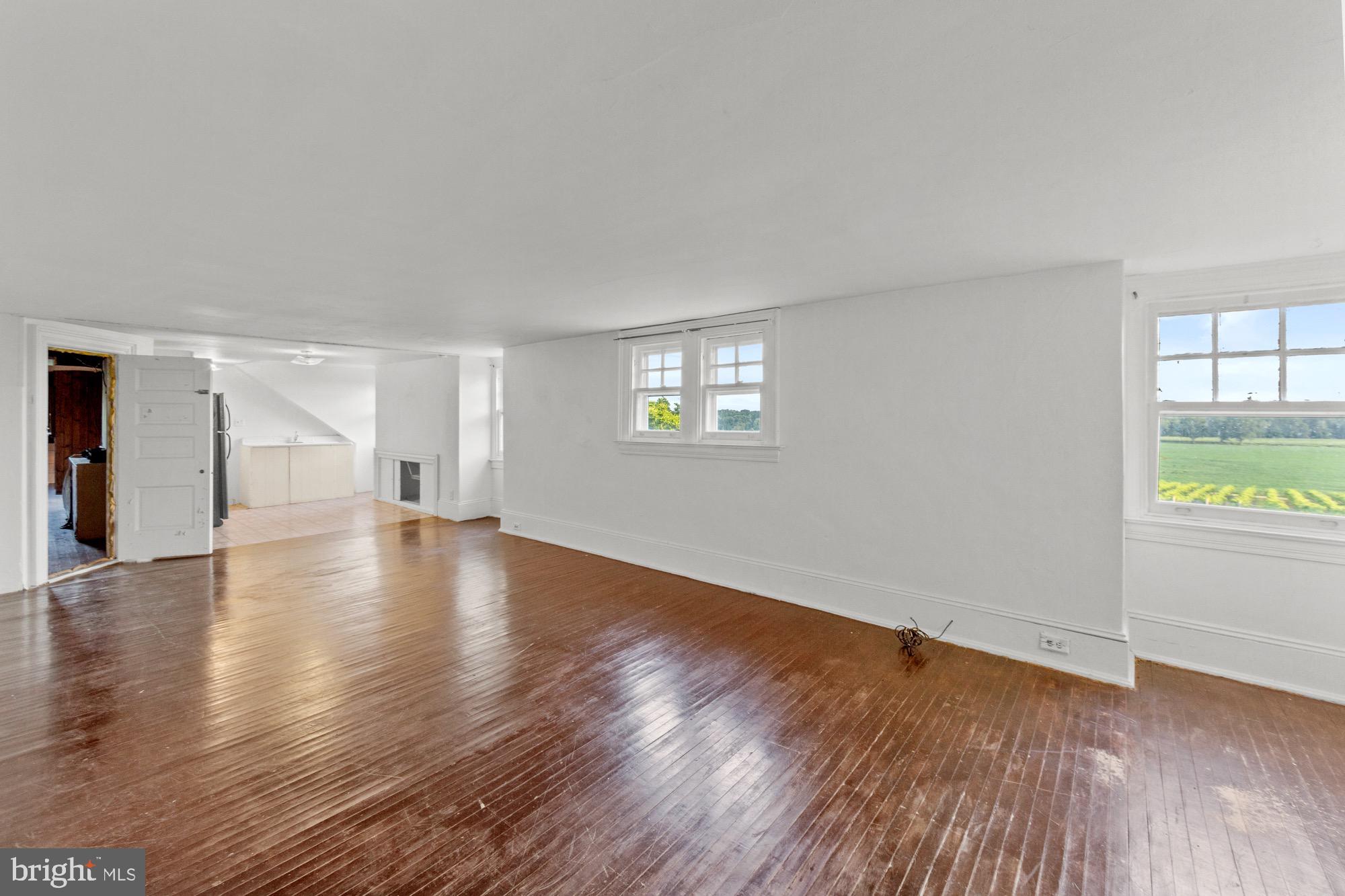 27058 Mt Pleasant Road Columbus, NJ 08022 - Photo 57 of 127 a view of an empty room with wooden floor and a window