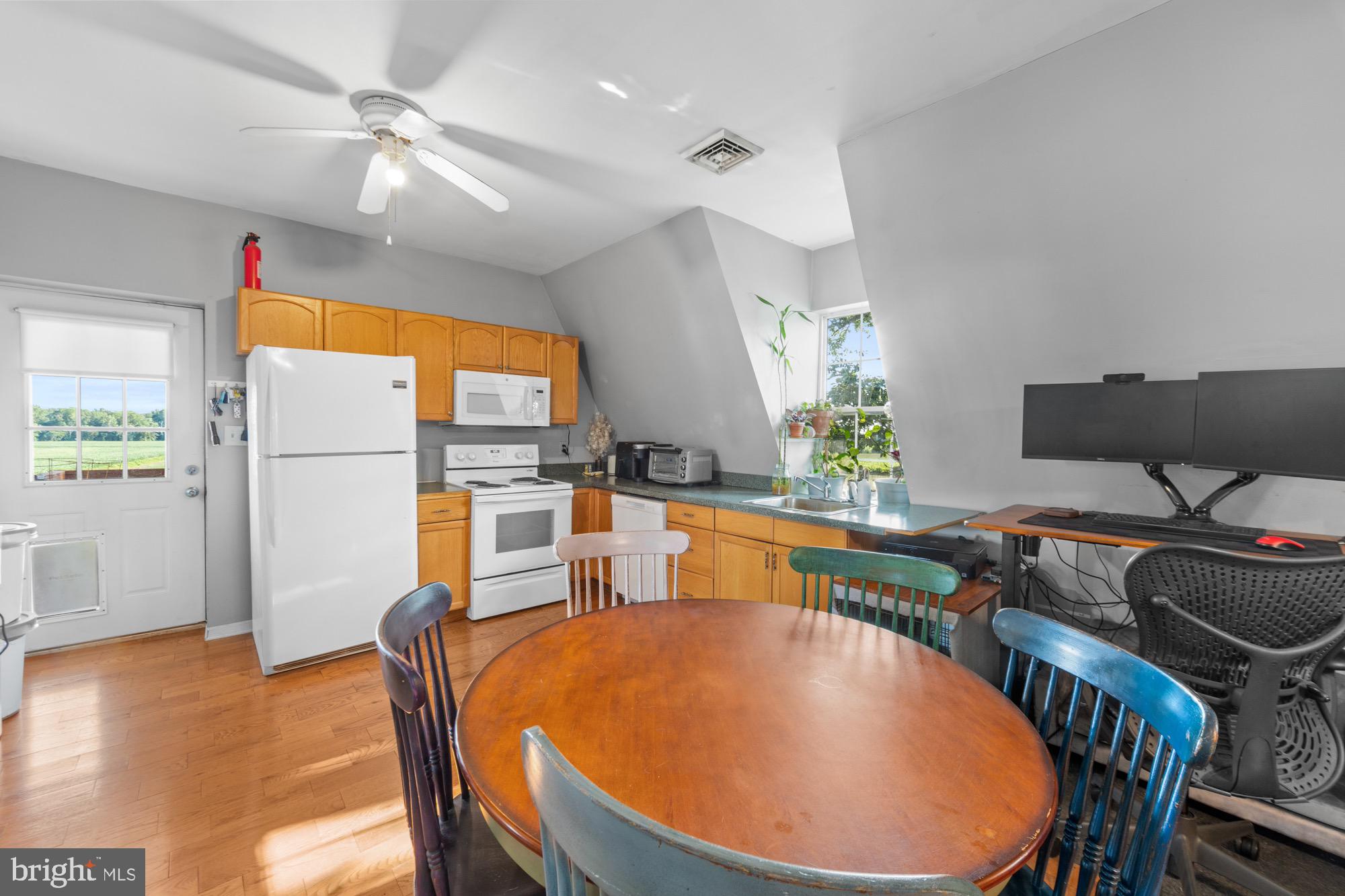 27058 Mt Pleasant Road Columbus, NJ 08022 - Photo 77 of 127 a dining room with furniture a rug potted plants and wooden floor