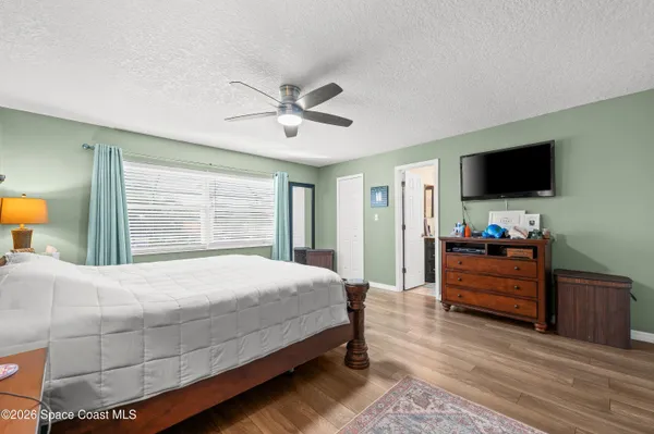 a bedroom with a bed and a flat screen tv