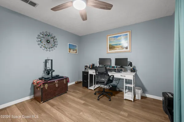 a view of a workspace with furniture and a window