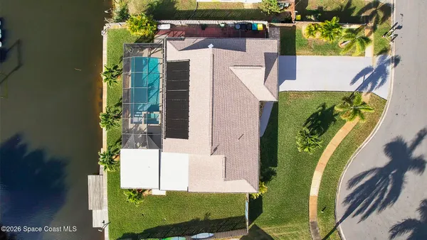 an aerial view of a house with a swimming pool