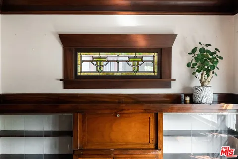 a bathroom with a sink and a potted plant