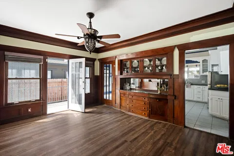 a view of a kitchen with an entryway and wooden floor