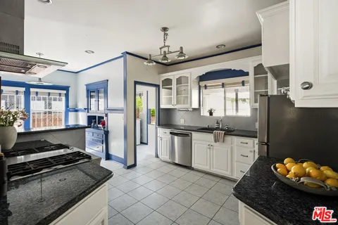 a kitchen with granite countertop a stove and a sink