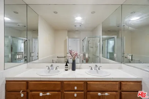 a bathroom with double vanity sinks and a mirror