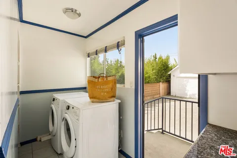 a view of a hallway with washer and dryer
