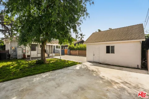 a view of a house with a yard and garage