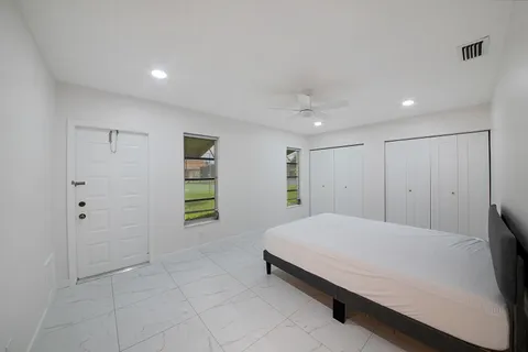 a bedroom with a bed and a shower
