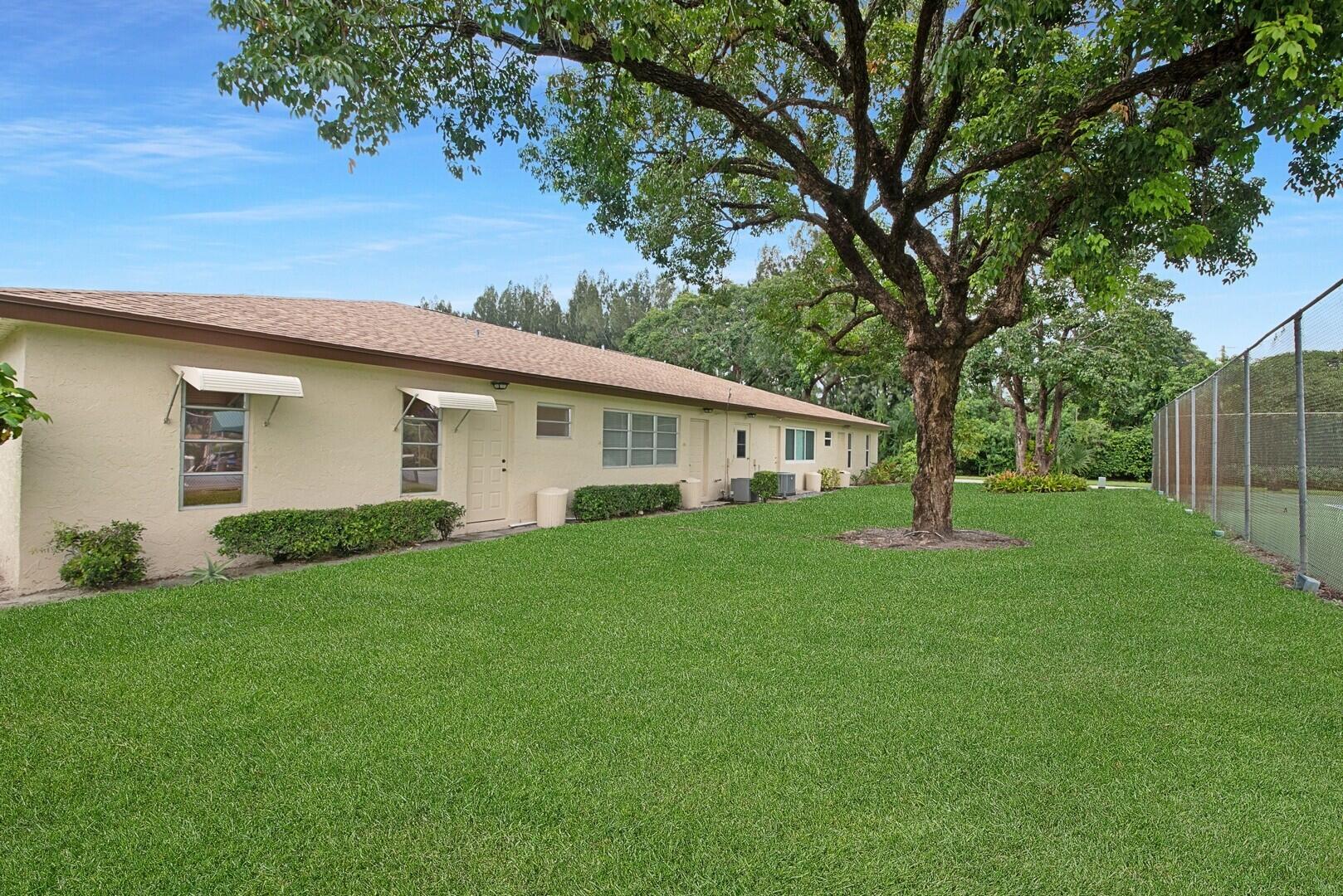 5220 Nesting Way, Unit D Delray Beach, FL 33484 - Photo 26 of 29 a view of a house with backyard and garden