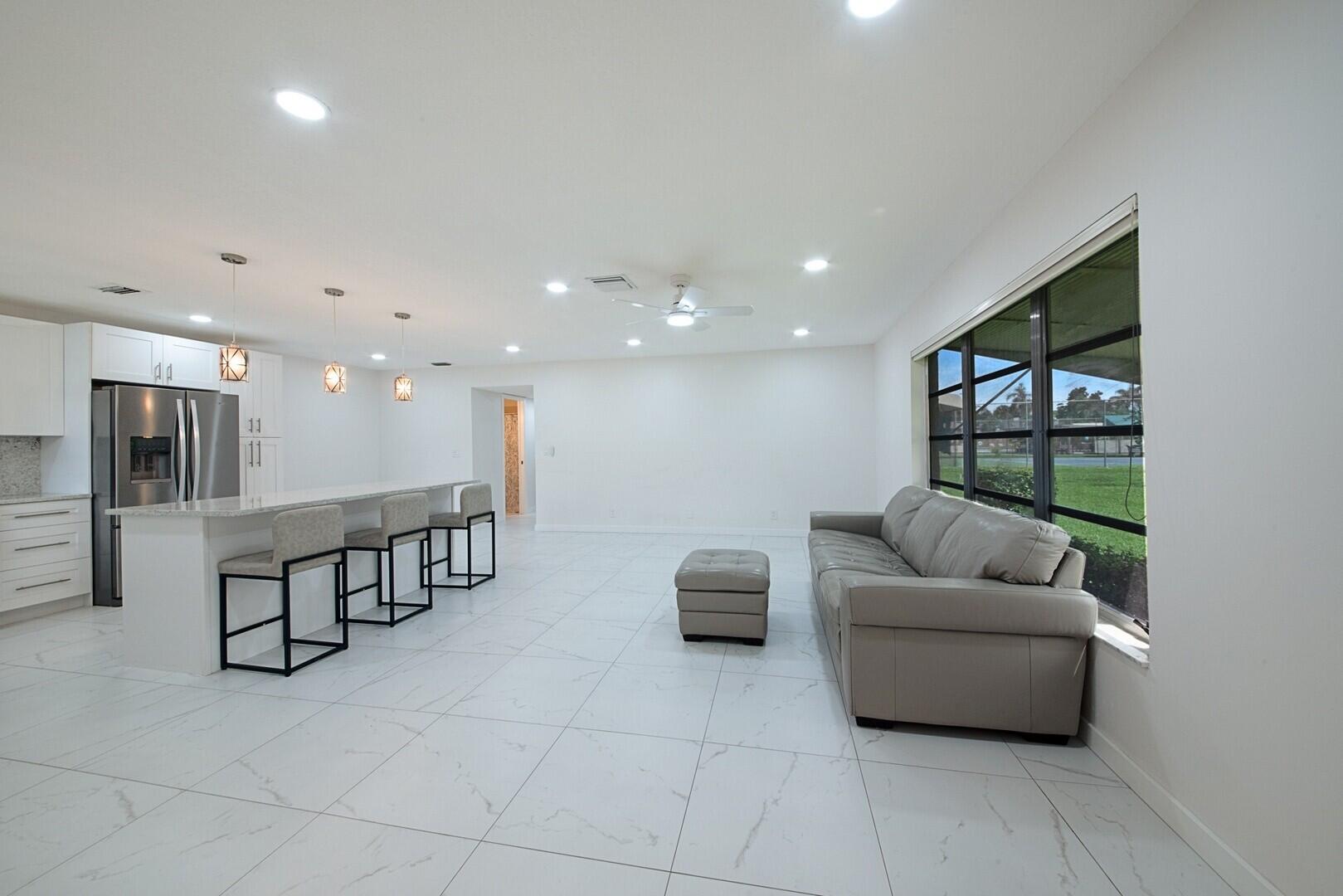 5220 Nesting Way, Unit D Delray Beach, FL 33484 - Photo 5 of 29 a living room with furniture and a large window