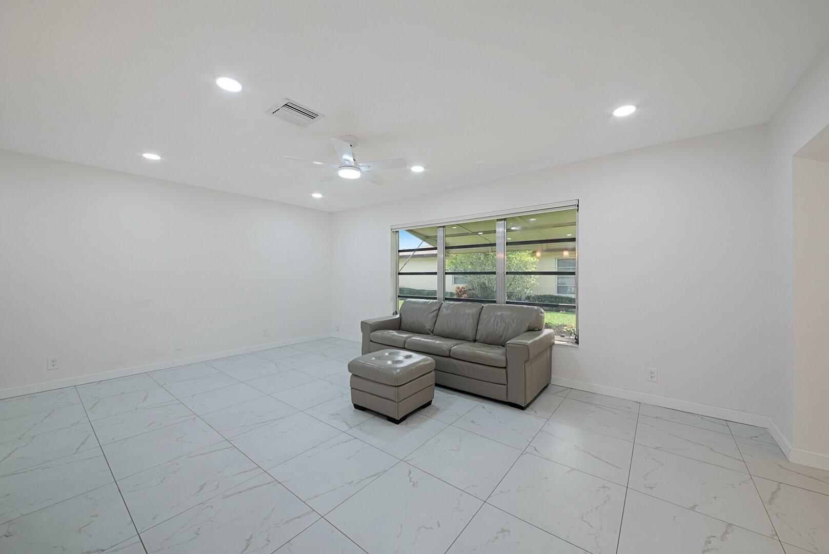 5220 Nesting Way, Unit D Delray Beach, FL 33484 - Photo 8 of 29 a living room with furniture and a window