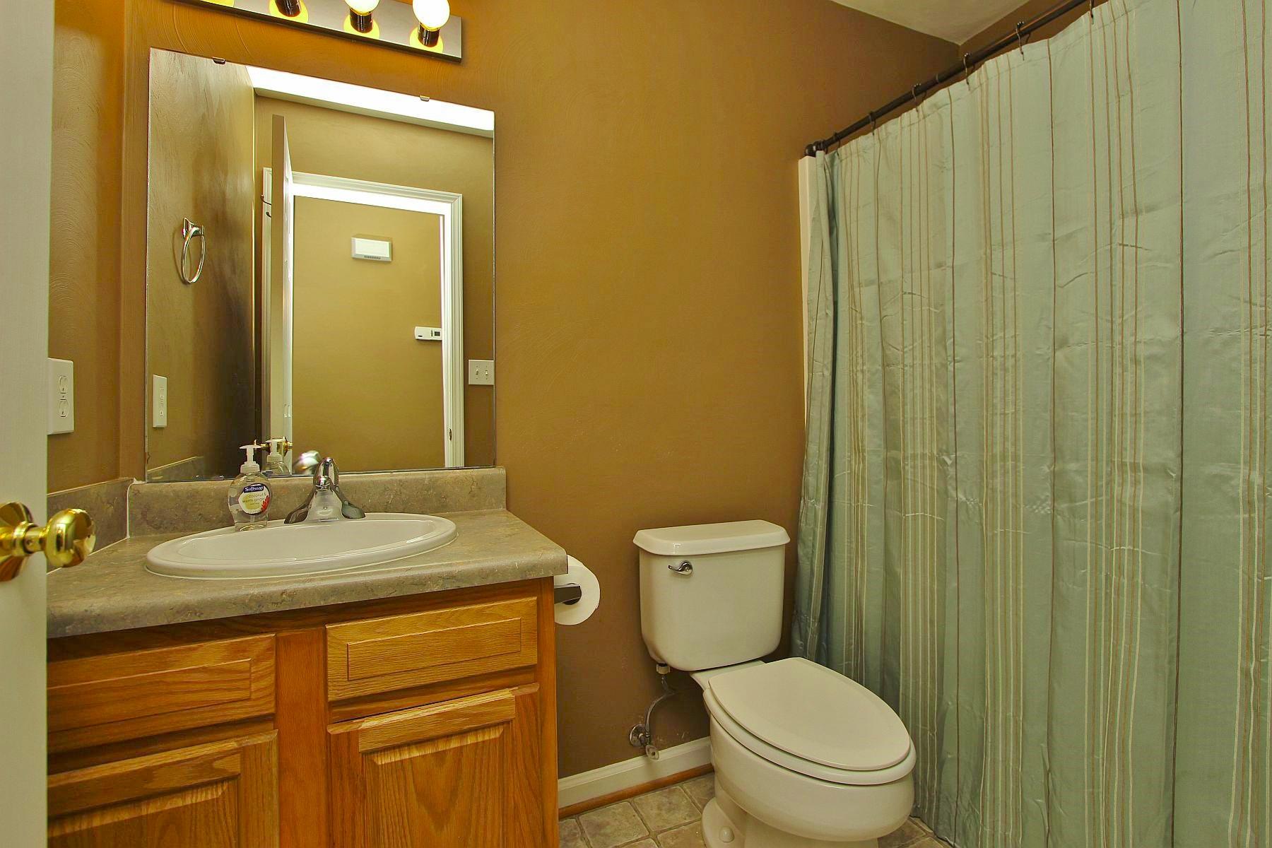 4239 Daugherty Road Salem, VA 24153 - Photo 9 of 38 a bathroom with a granite countertop toilet sink and mirror