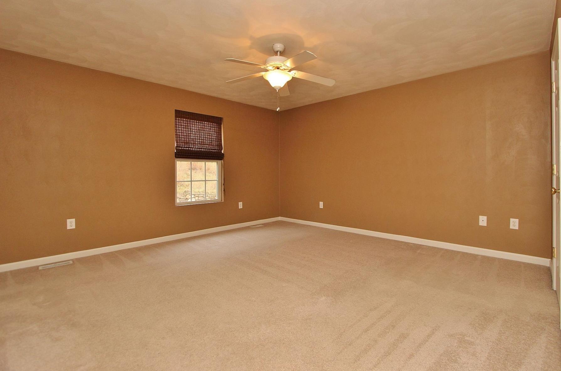 4239 Daugherty Road Salem, VA 24153 - Photo 10 of 38 an empty room with a chandelier fan and windows