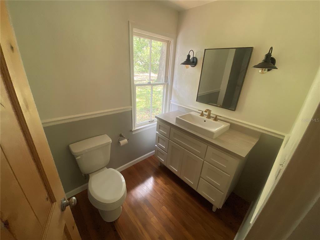 3023 Southeast 13th Place Gainesville, FL 32641 - Photo 11 of 29 a bathroom with a toilet sink and mirror