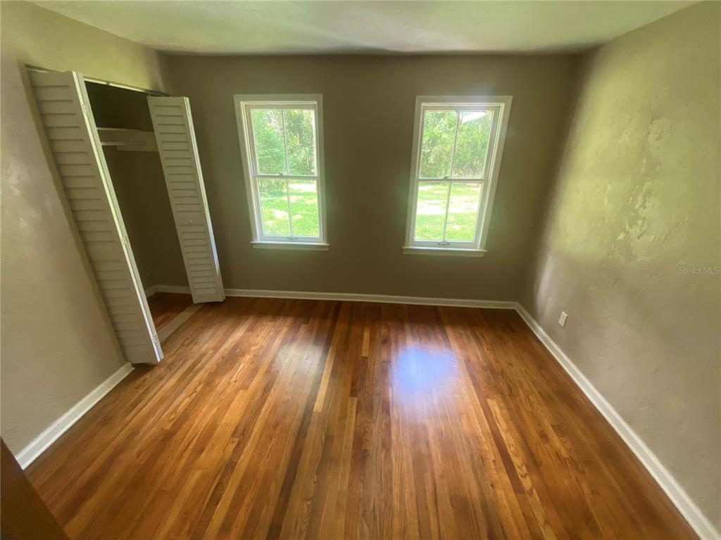 3023 Southeast 13th Place Gainesville, FL 32641 - Photo 13 of 29 a view of room with window and wooden floor
