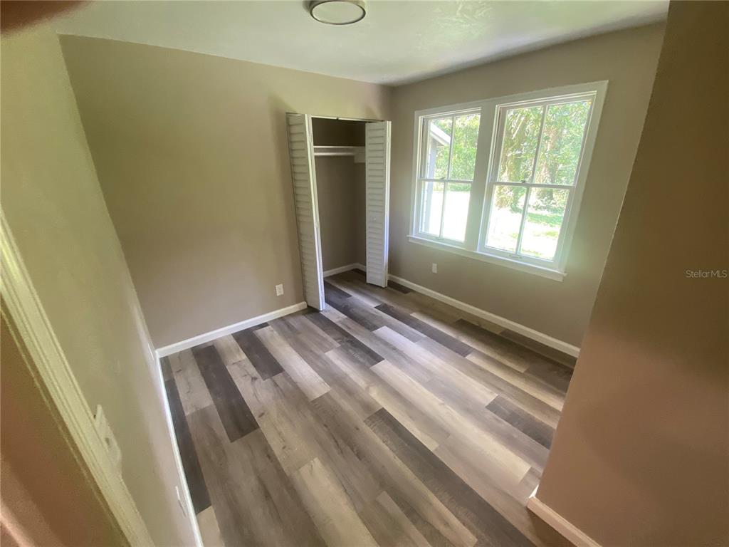3023 Southeast 13th Place Gainesville, FL 32641 - Photo 16 of 29 a view of wooden floor and windows in a room