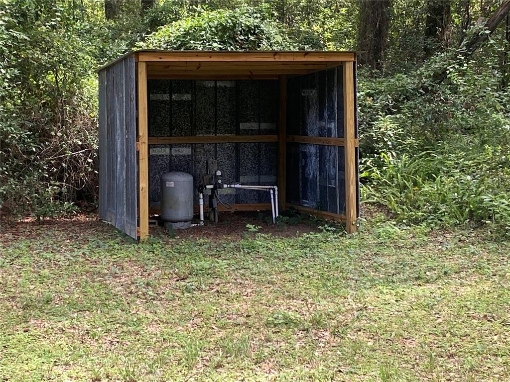 3023 Southeast 13th Place Gainesville, FL 32641 - Photo 25 of 29 a view of backyard with wooden fence and large trees