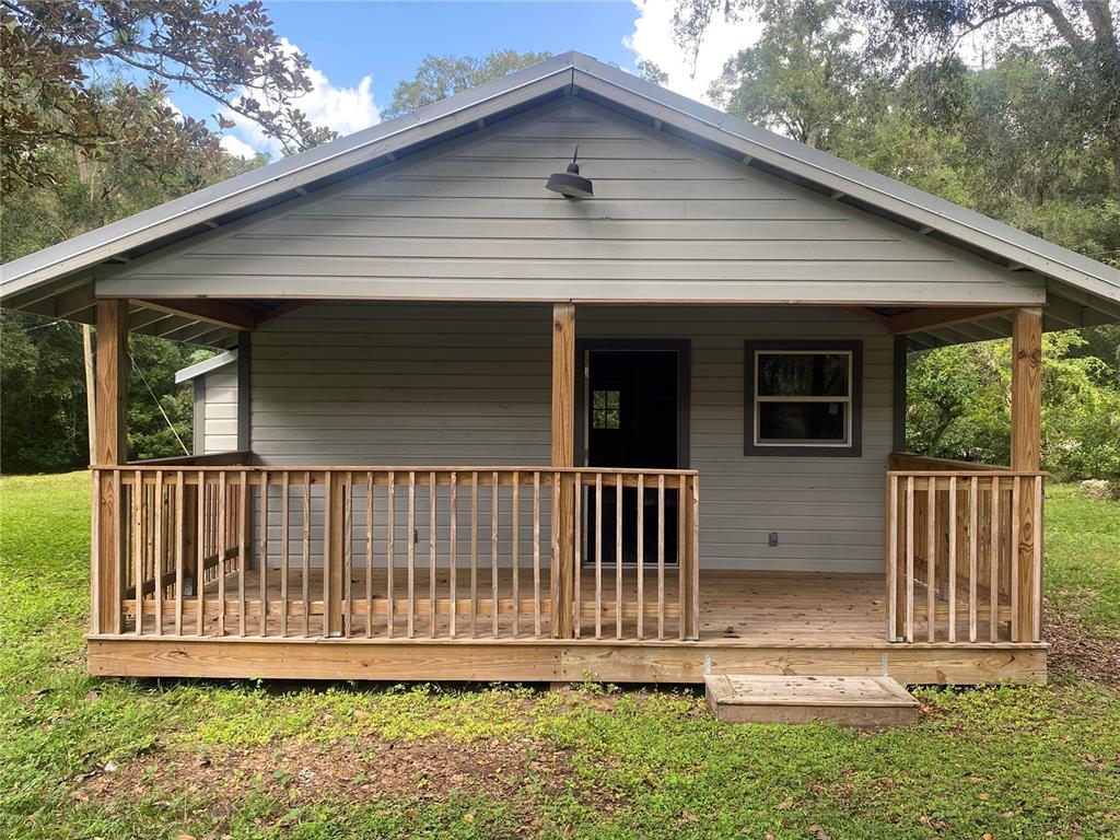 3023 Southeast 13th Place Gainesville, FL 32641 - Photo 4 of 29 a white house with a small yard and a large window
