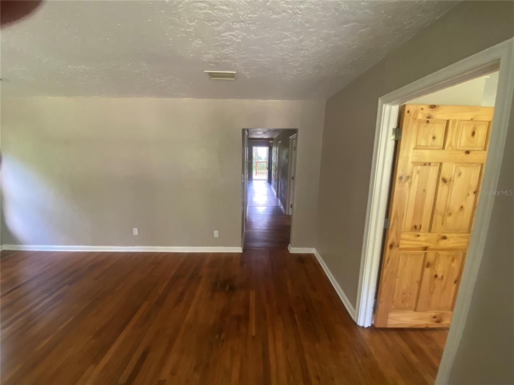 3023 Southeast 13th Place Gainesville, FL 32641 - Photo 10 of 29 a view of a hallway with wooden floor