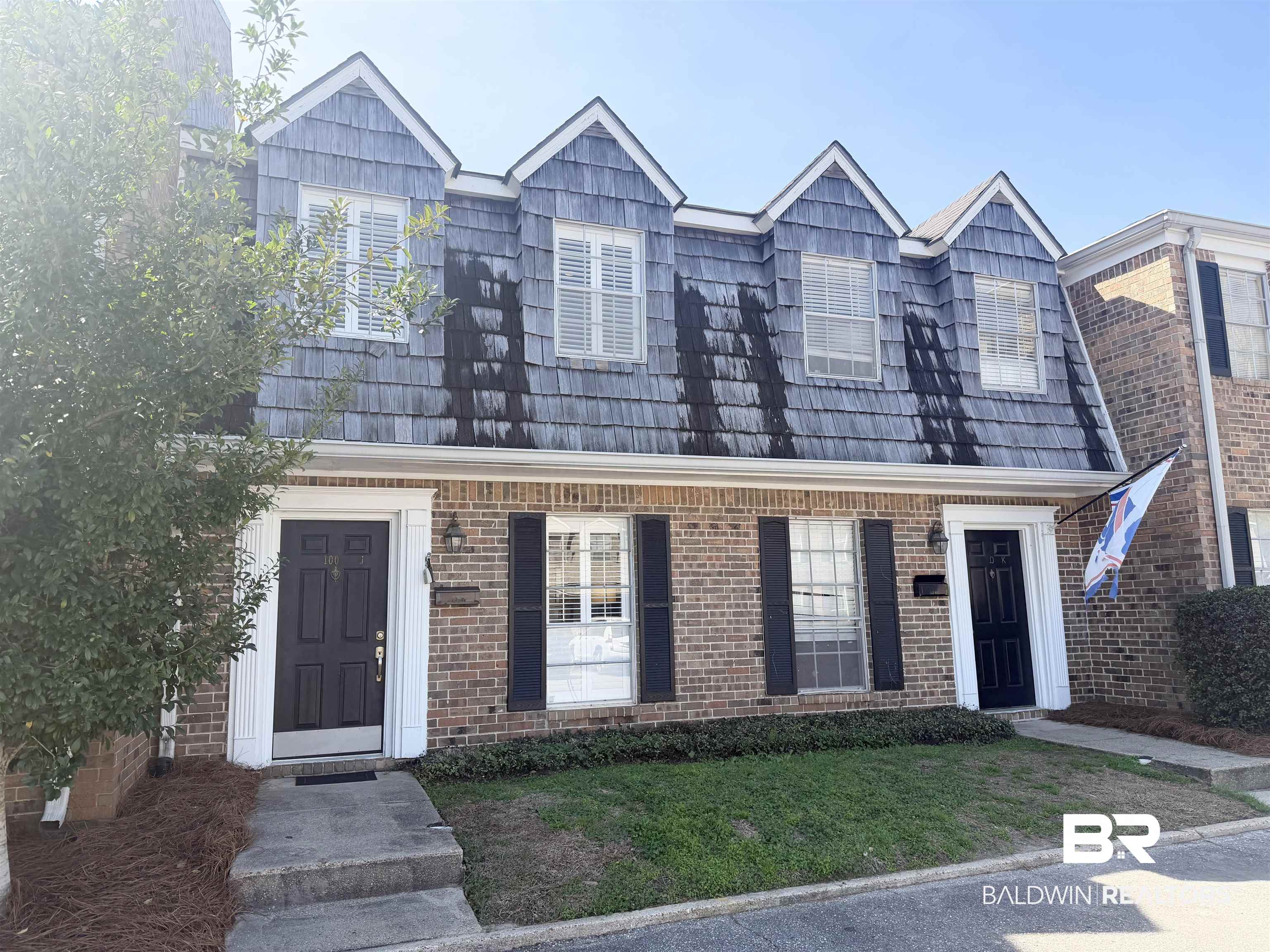 100 Du Rhu Drive, Unit J Mobile, AL 36608 - Photo 1 of 17 View of front of home with a front lawn and brick siding