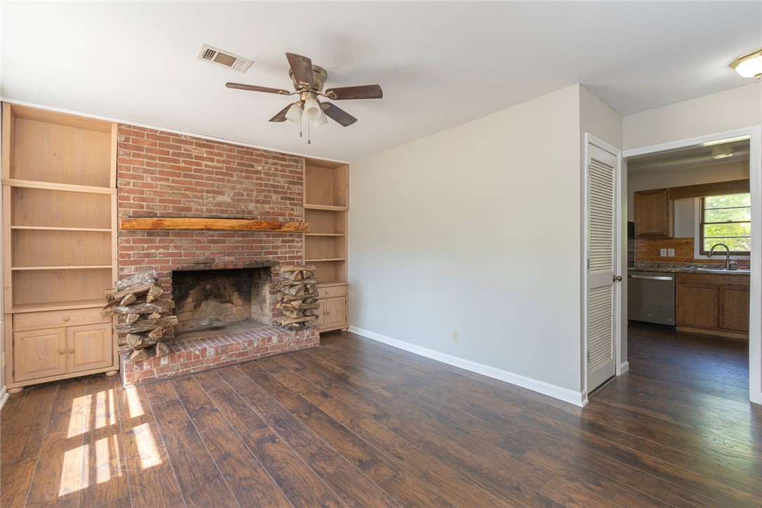 820 Travis Road Anderson, SC 29626 - Photo 12 of 46 This inviting living space features rich hardwood floors and a striking brick fireplace.