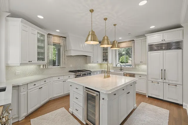 a kitchen with white cabinets and white appliances