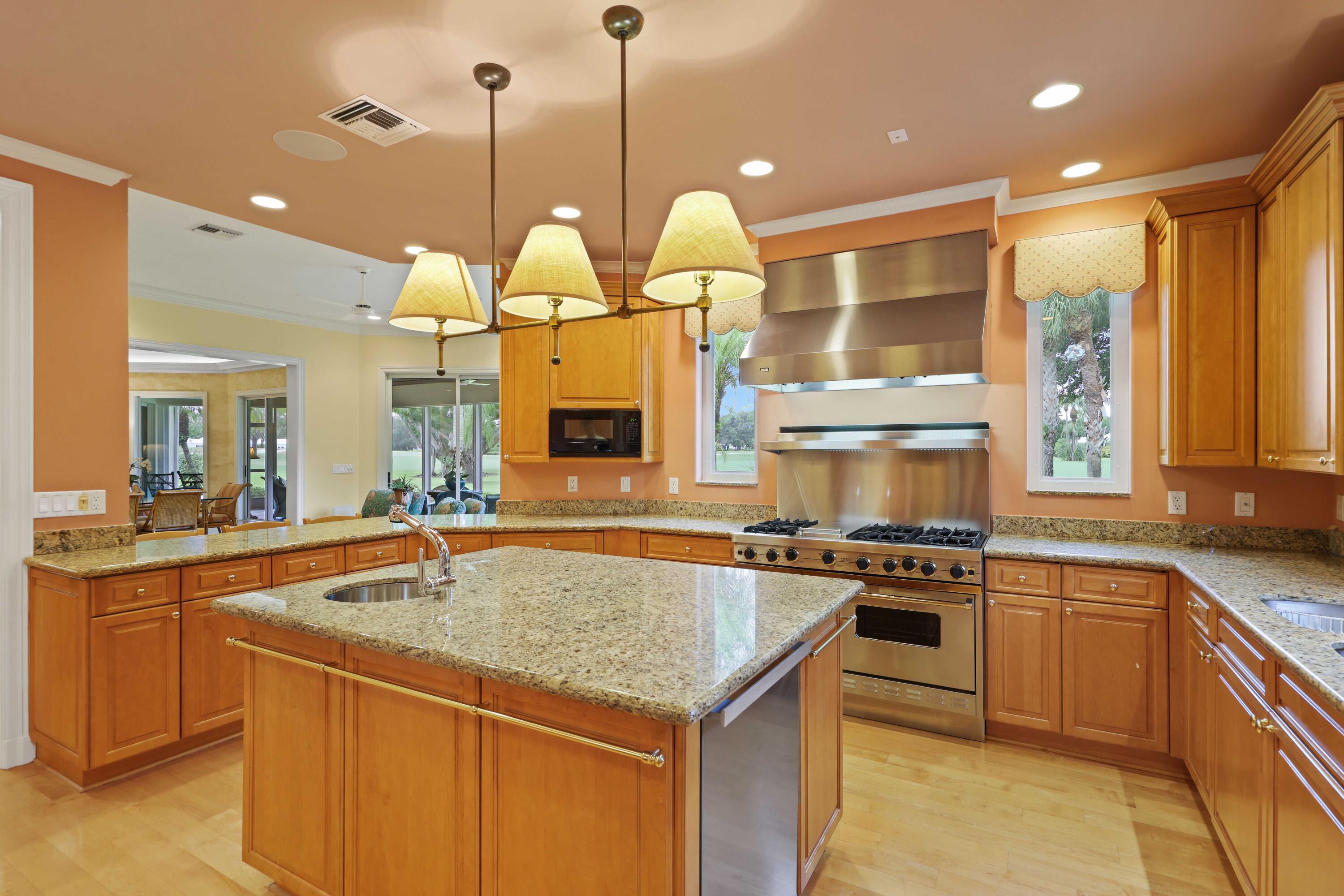 5 Country Road East, Unit A Boynton Beach, FL 33436 - Photo 21 of 51 a kitchen with a stove a sink a counter space and a view of living room