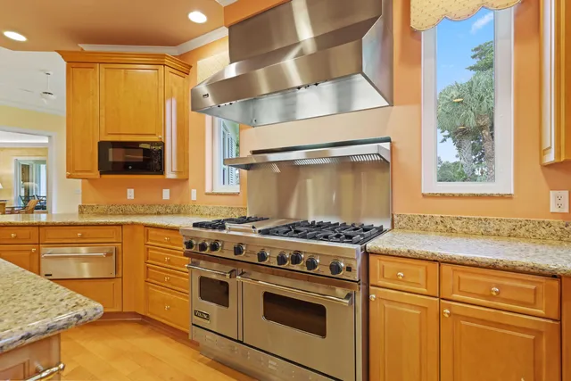a kitchen with stainless steel appliances granite countertop a stove and a sink