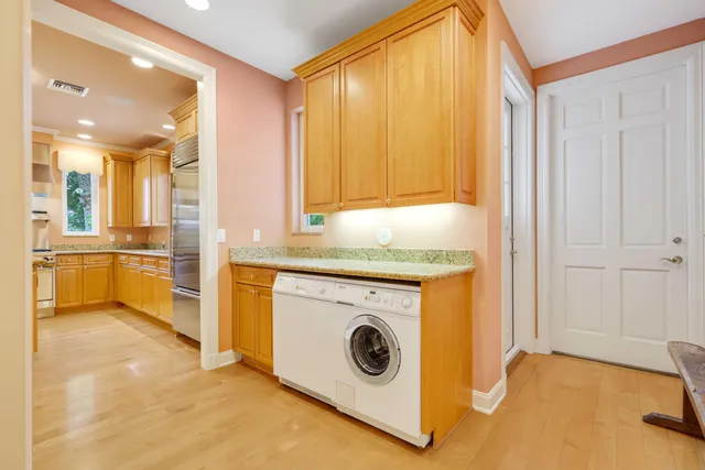 a utility room with cabinets washer and dryer