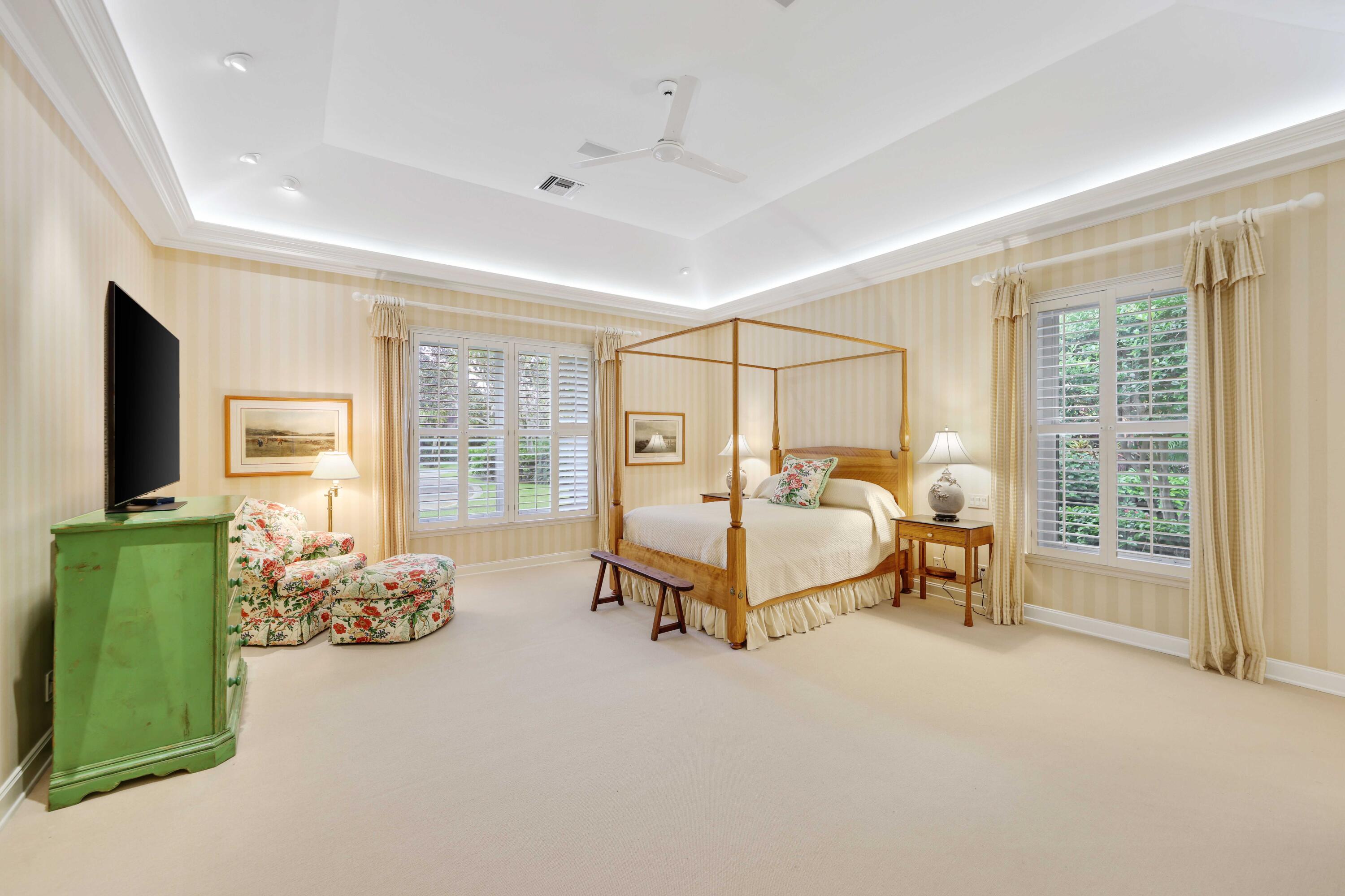 5 Country Road East, Unit A Boynton Beach, FL 33436 - Photo 27 of 51 a spacious bedroom with a bed and a large window