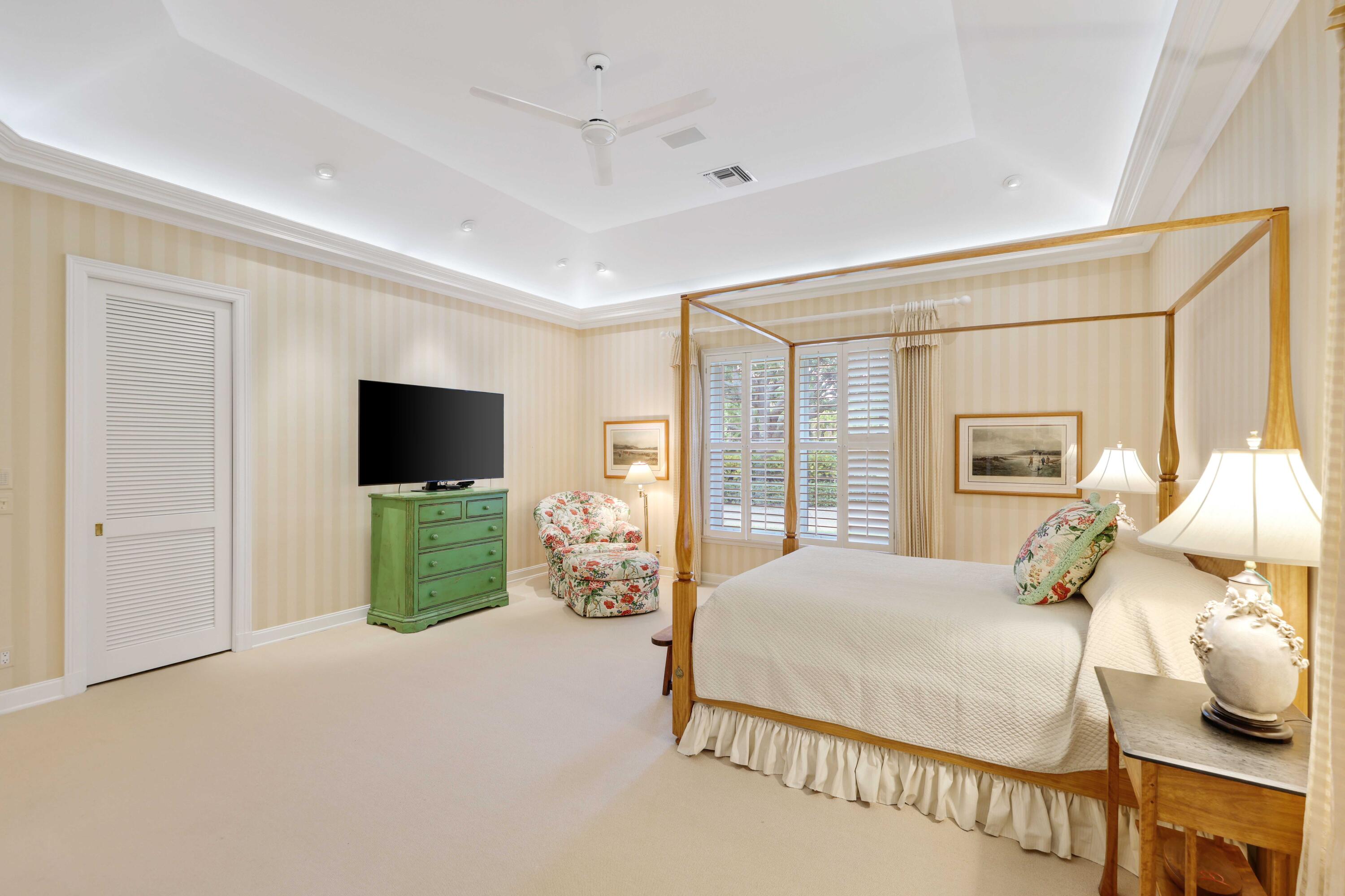 5 Country Road East, Unit A Boynton Beach, FL 33436 - Photo 29 of 51 a bedroom with a bed and a flat screen tv