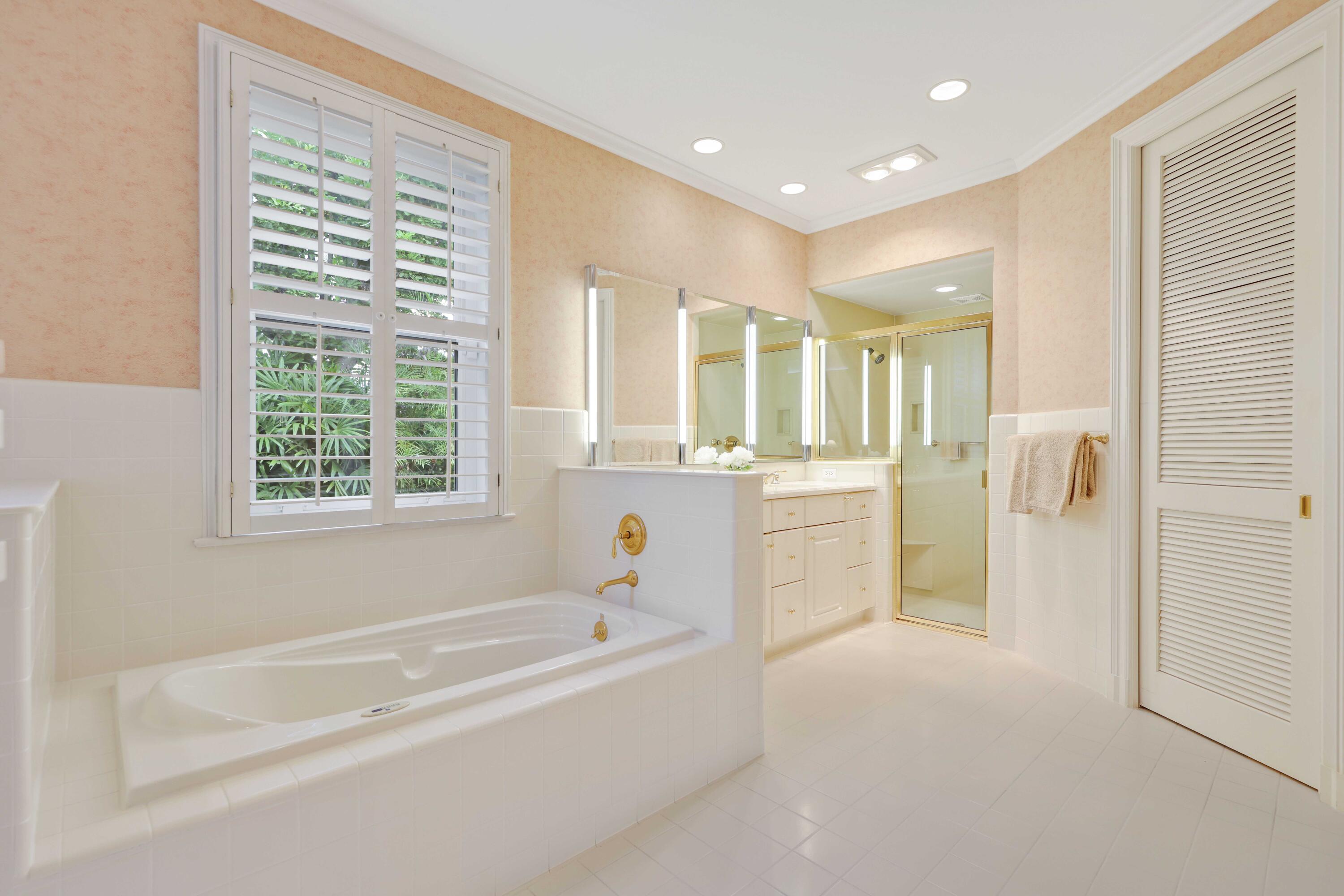 5 Country Road East, Unit A Boynton Beach, FL 33436 - Photo 32 of 51 a bathroom with a bathtub and a shower