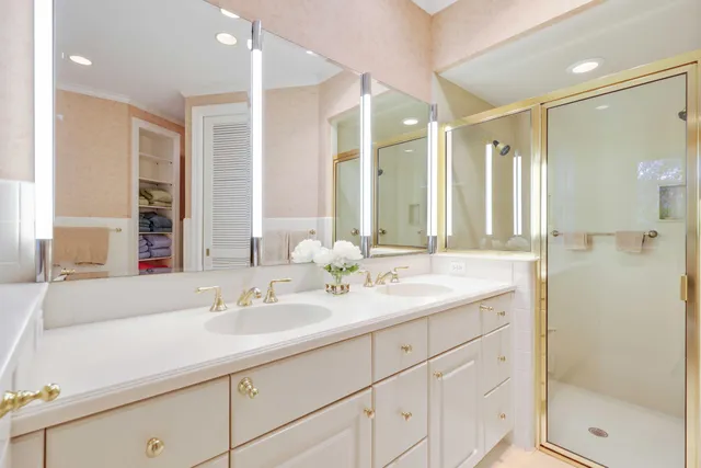a bathroom with a shower sink and mirror