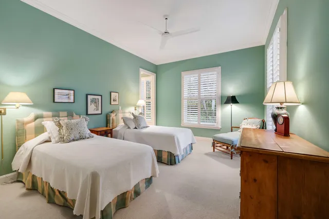 a bedroom with two beds and a chandelier