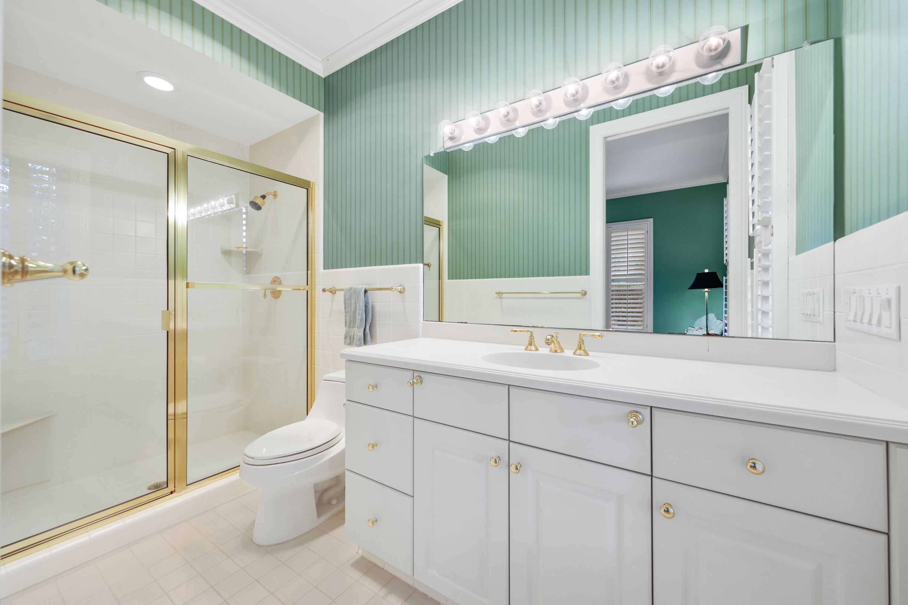 5 Country Road East, Unit A Boynton Beach, FL 33436 - Photo 37 of 51 a bathroom with a granite countertop sink mirror and toilet