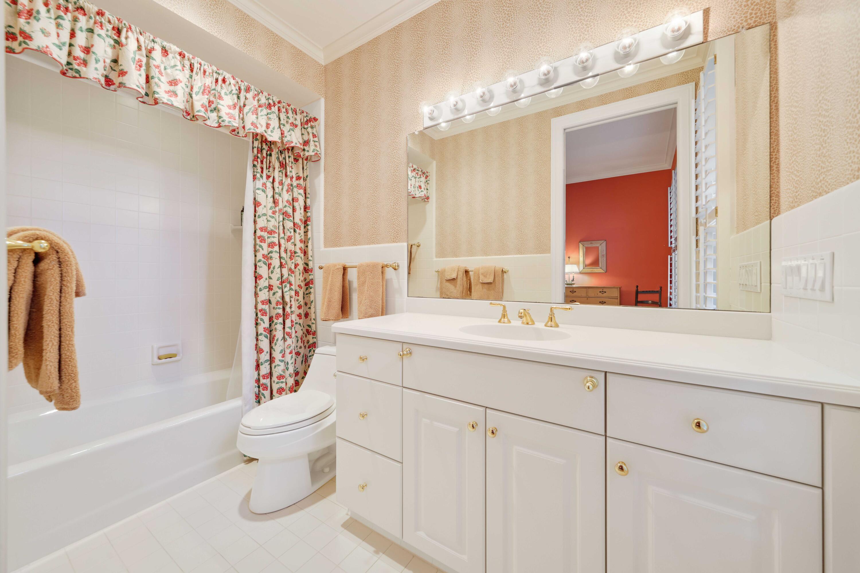 5 Country Road East, Unit A Boynton Beach, FL 33436 - Photo 39 of 51 a bathroom with a toilet sink and mirror