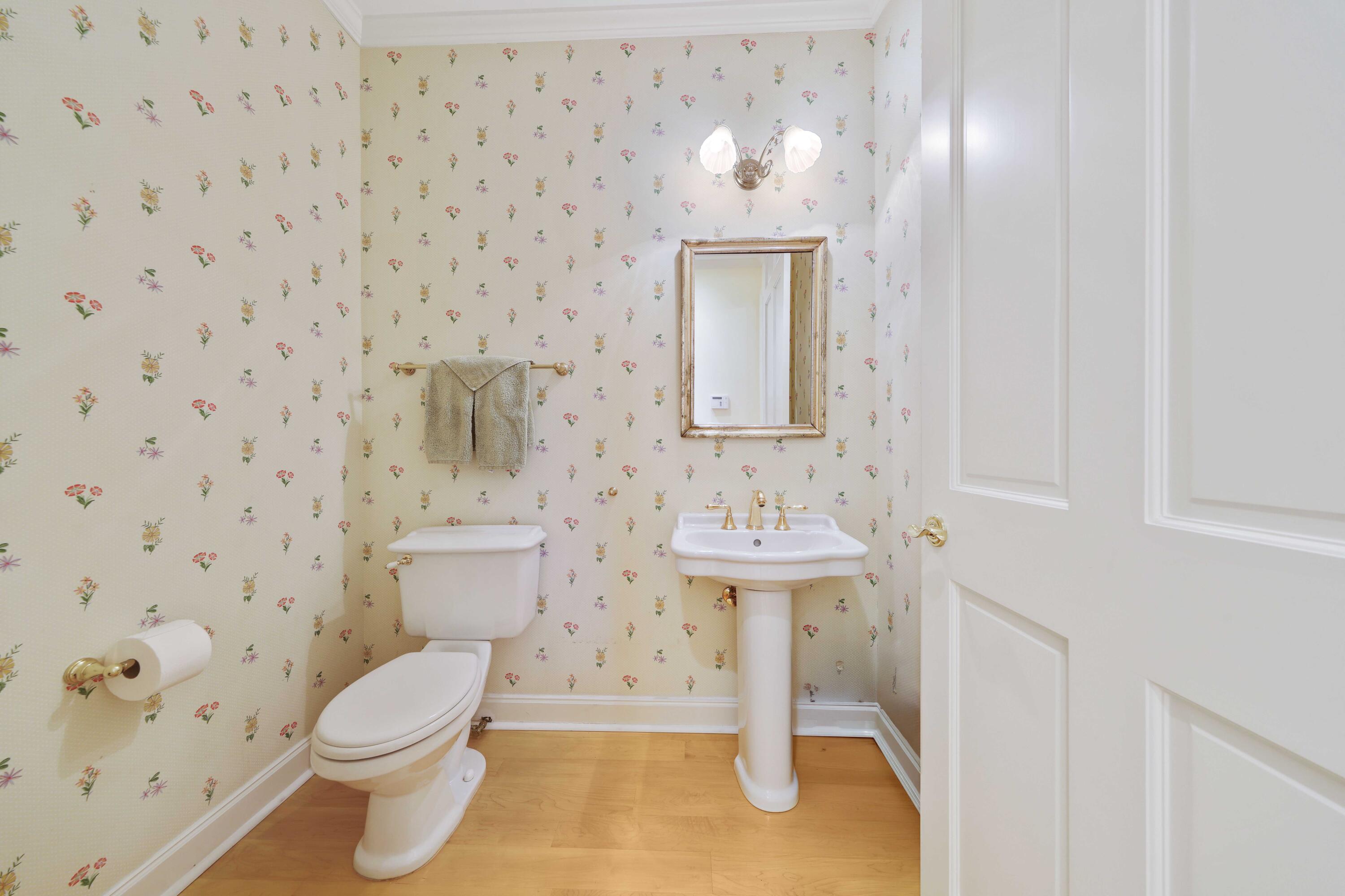 5 Country Road East, Unit A Boynton Beach, FL 33436 - Photo 40 of 51 a bathroom with a toilet sink and mirror