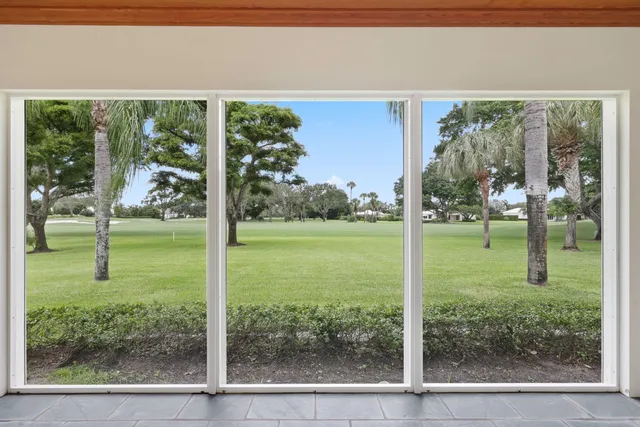 a living room with couch and a floor to ceiling window