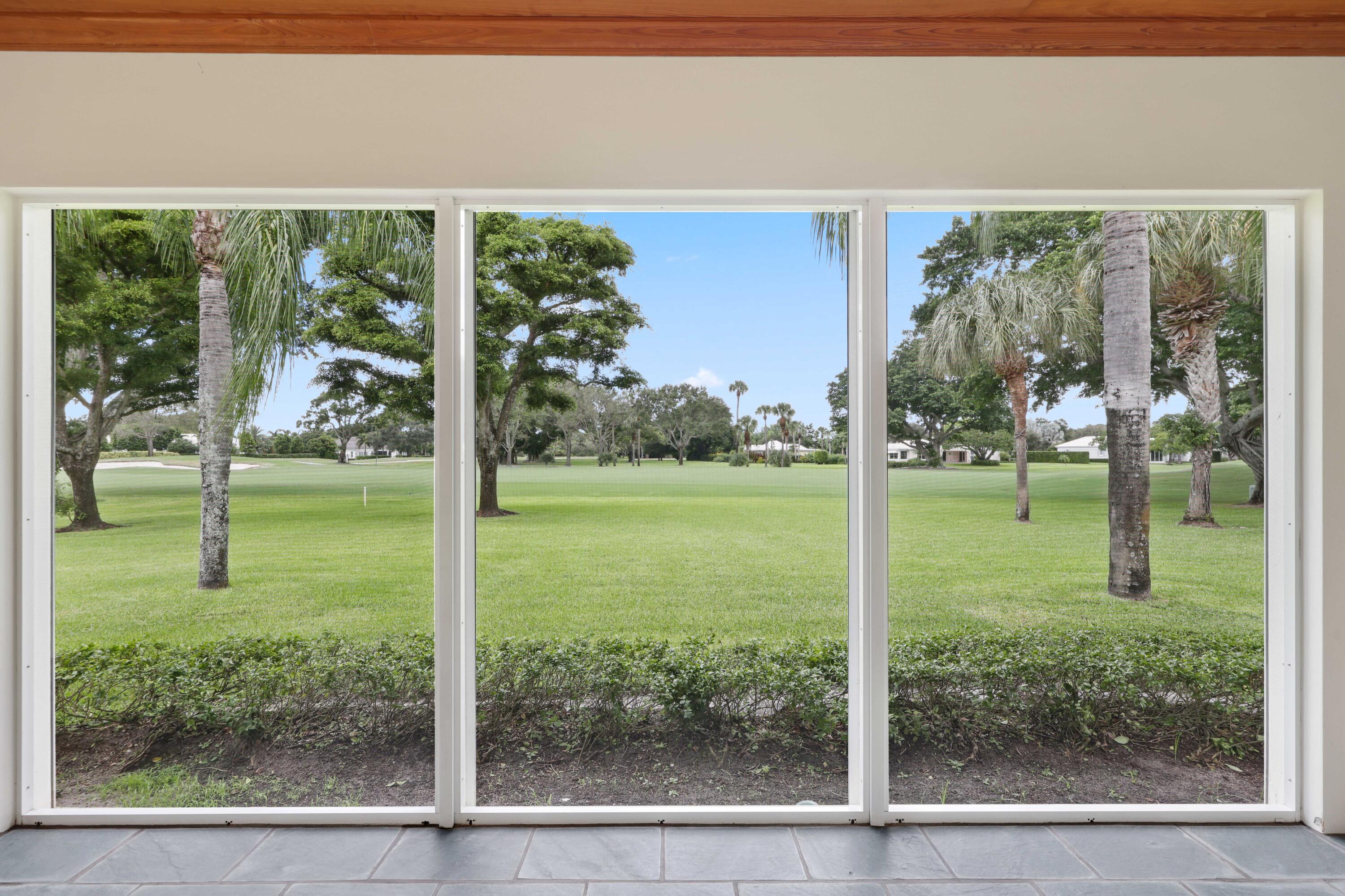 5 Country Road East, Unit A Boynton Beach, FL 33436 - Photo 42 of 51 a view of a trees in a yard