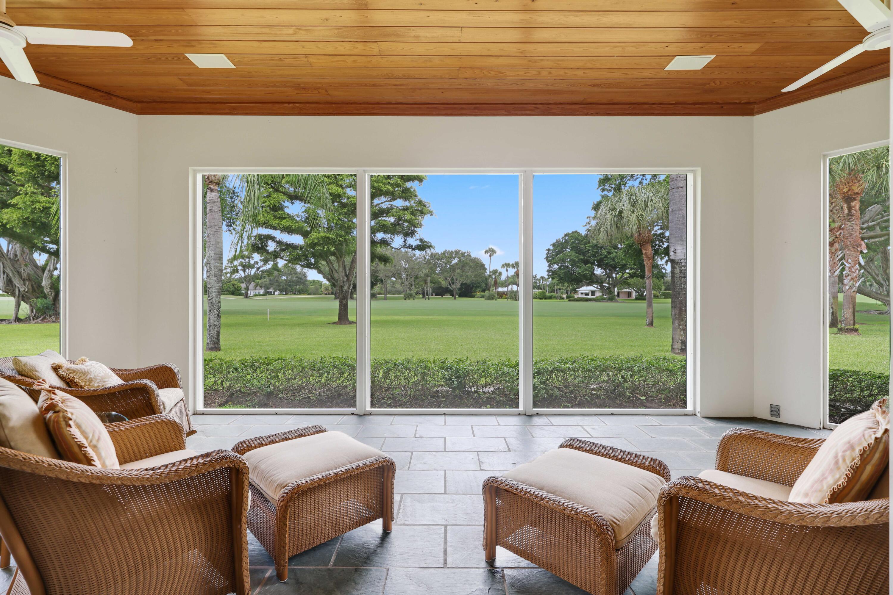 5 Country Road East, Unit A Boynton Beach, FL 33436 - Photo 43 of 51 a living room with couch and a floor to ceiling window