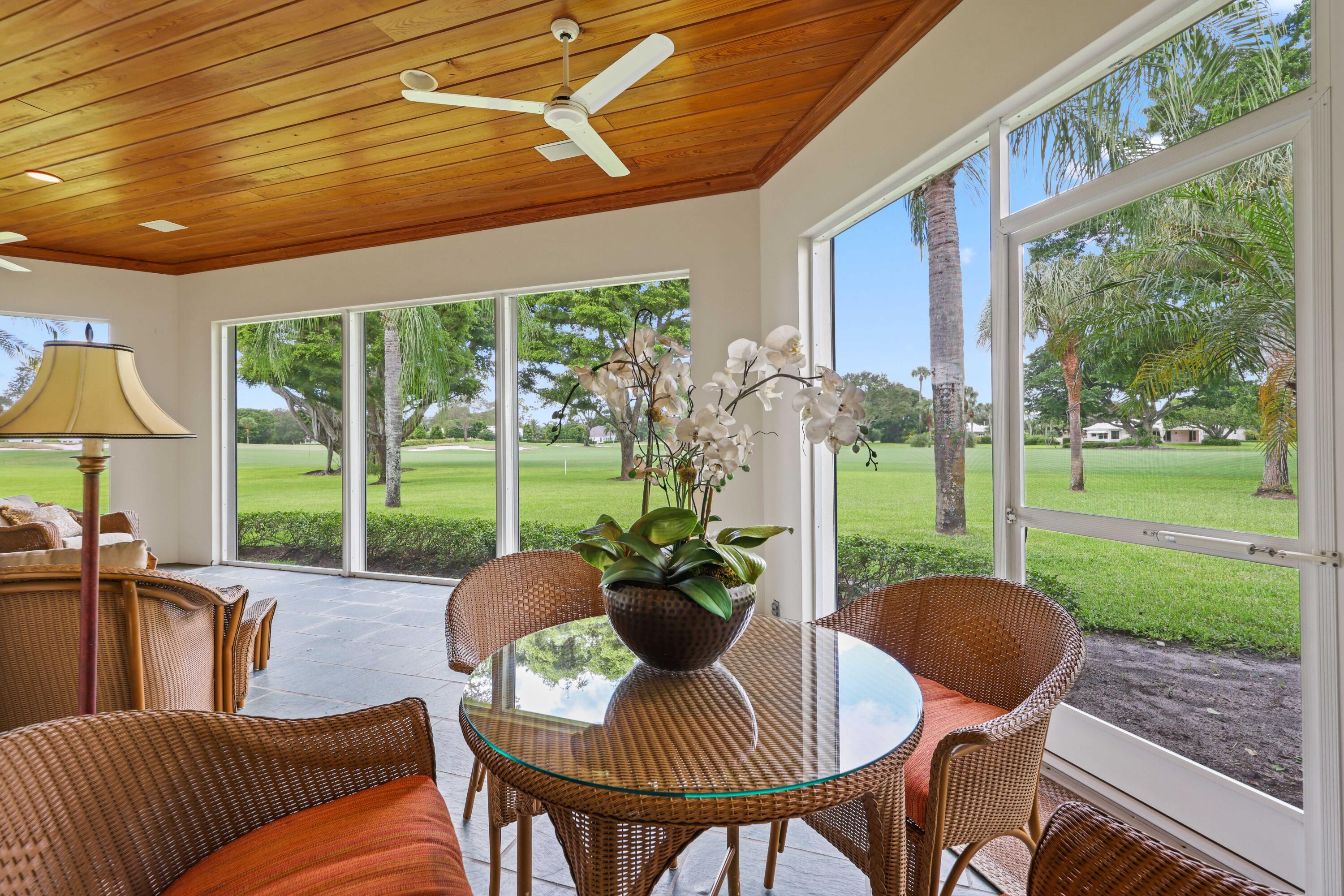 5 Country Road East, Unit A Boynton Beach, FL 33436 - Photo 44 of 51 a view of a patio with a table chairs and a backyard