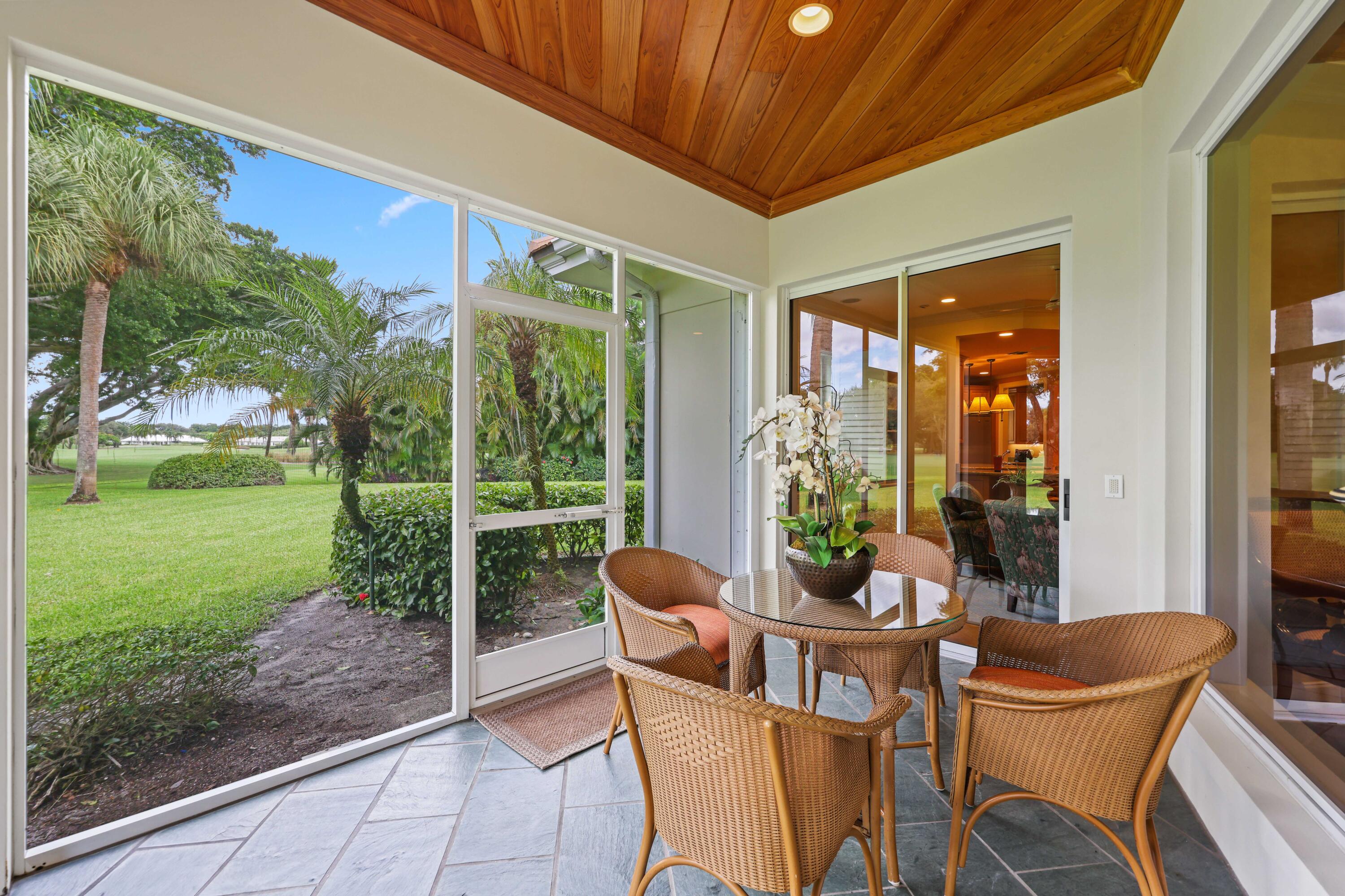 5 Country Road East, Unit A Boynton Beach, FL 33436 - Photo 45 of 51 a view of an outdoor dining space with a table and chairs