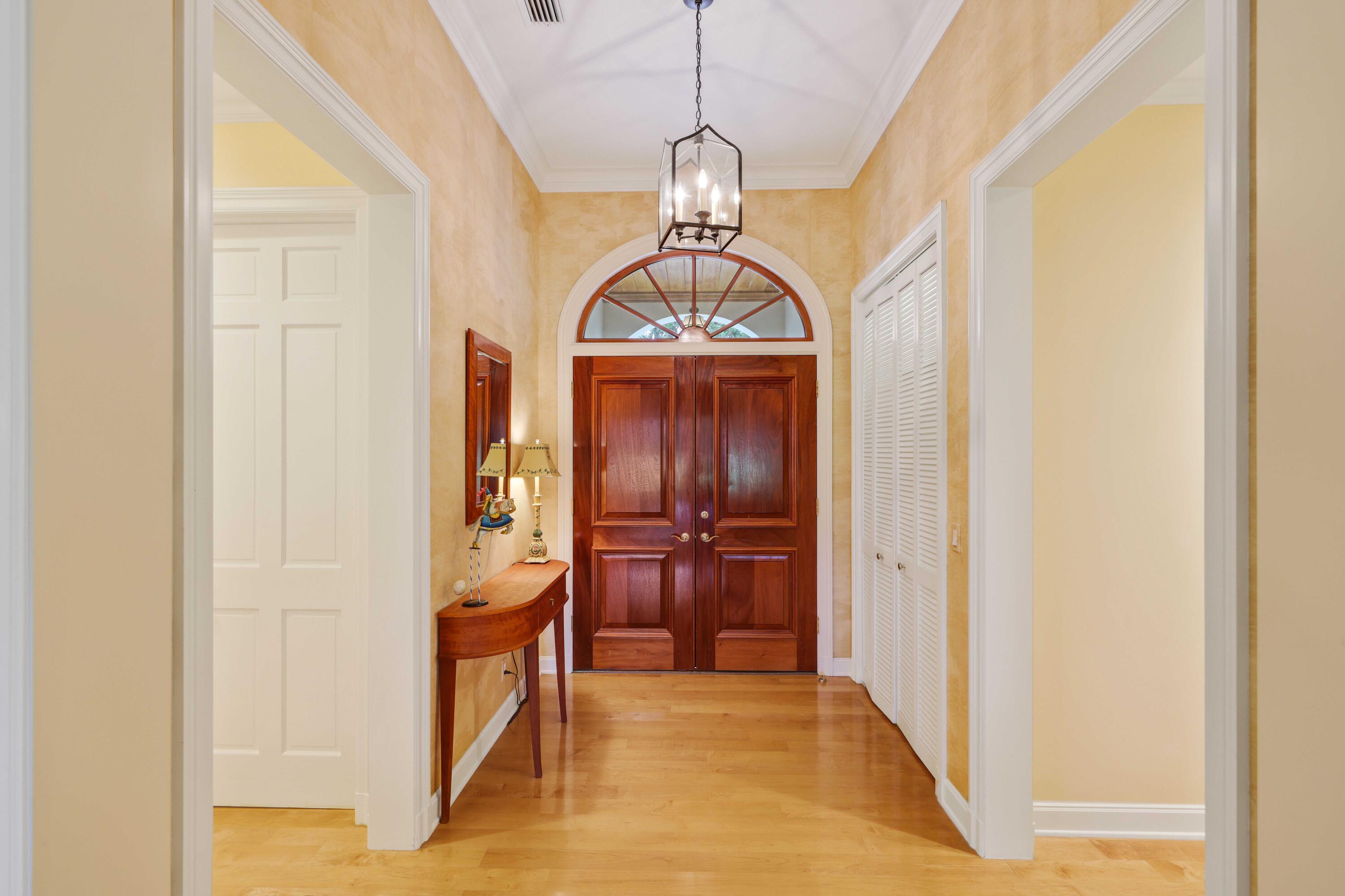 5 Country Road East, Unit A Boynton Beach, FL 33436 - Photo 6 of 51 a view of hallway with chandelier and a living room