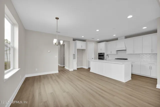 a view of kitchen with cabinets and wooden floor