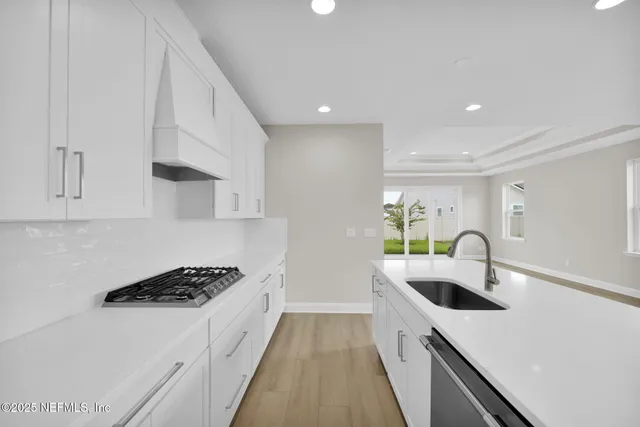 a kitchen with granite countertop a sink and cabinets