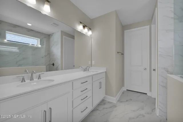 a bathroom with double vanity sink and a mirror