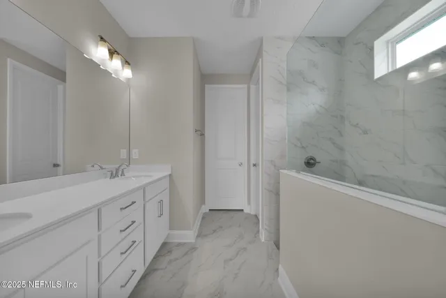 a bathroom with a double vanity sink a toilet and a mirror